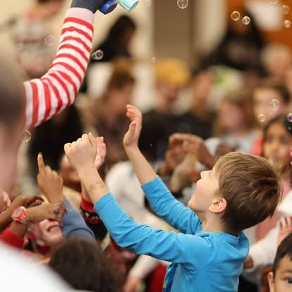 A boy reaching for bubbles at a Vision Church family event